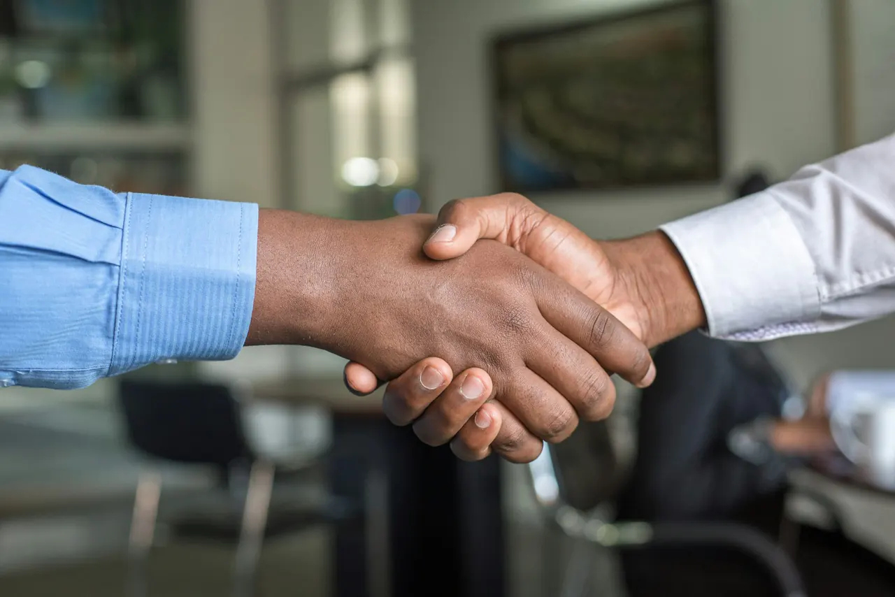 Two people discussing an agreement across a table