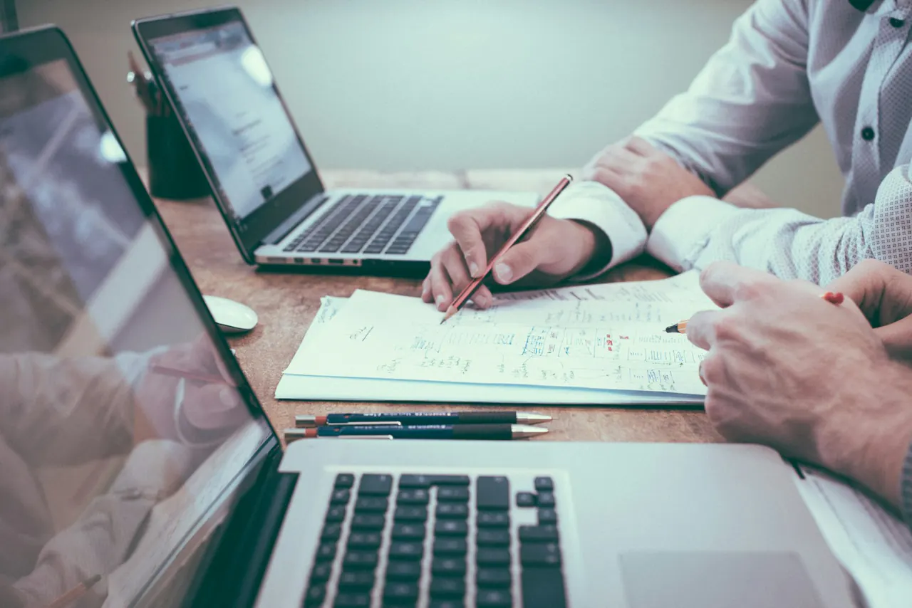 People reviewing financial documents at a desk